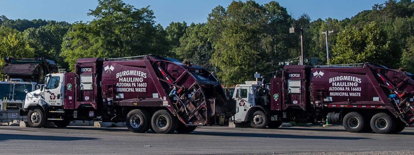 Four parked Burgmeiers Trash Trucks e1664820700918
